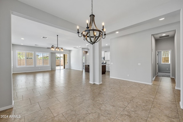 interior space with ceiling fan with notable chandelier