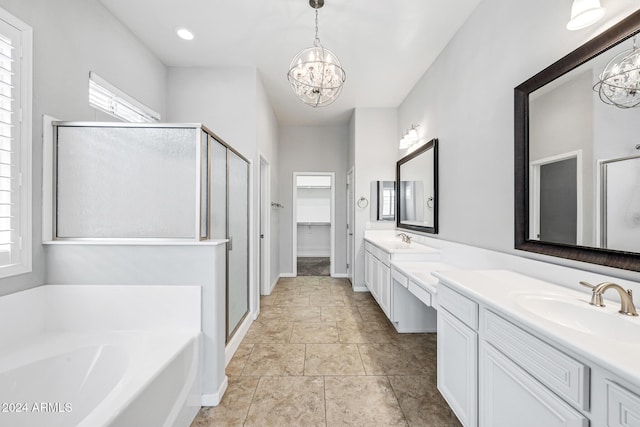 bathroom with vanity, separate shower and tub, and an inviting chandelier