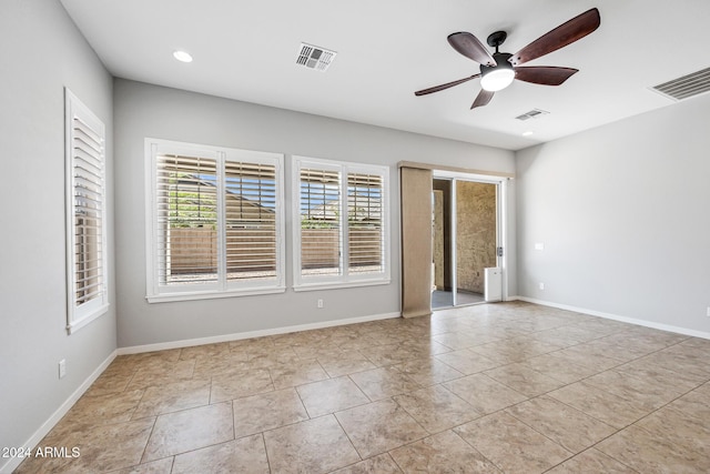 empty room featuring ceiling fan and light tile patterned flooring