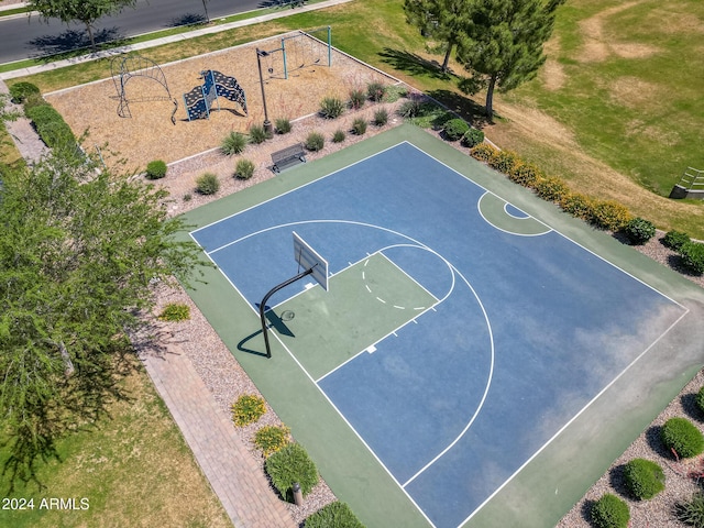 view of basketball court with a playground and a yard