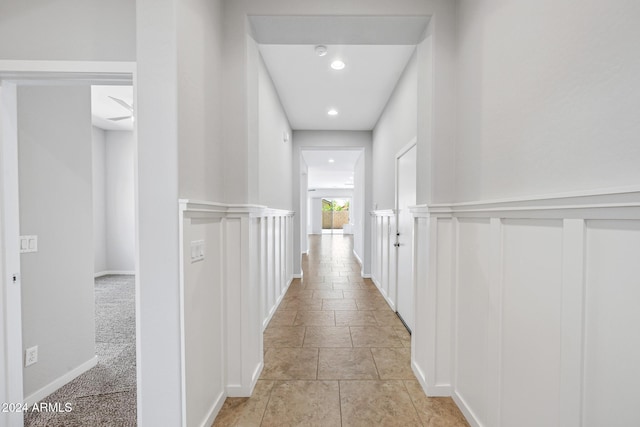 hall with light colored carpet