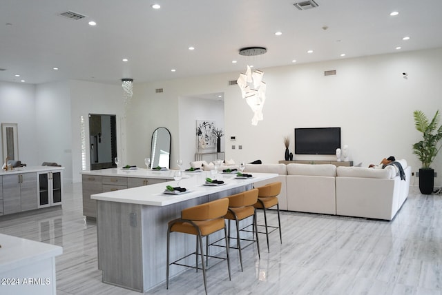 kitchen with a breakfast bar area, a large island, and light hardwood / wood-style floors