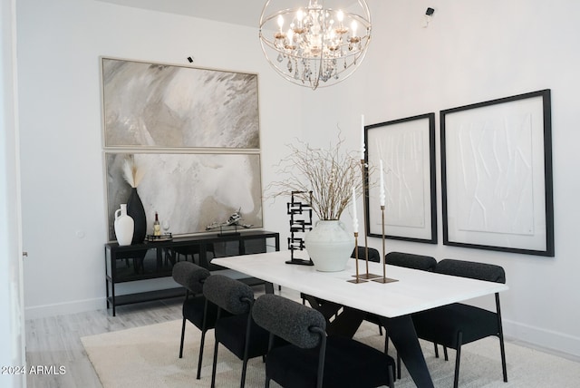 dining area featuring a chandelier and light hardwood / wood-style floors