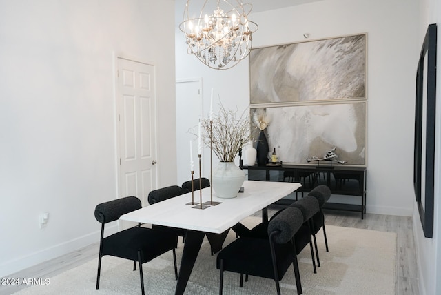 dining room featuring light hardwood / wood-style floors and a notable chandelier