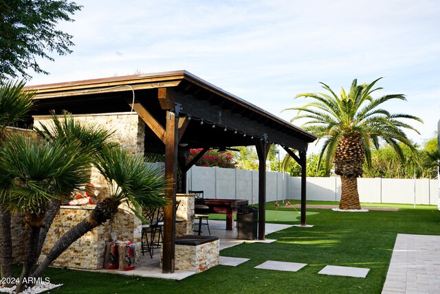 exterior space with a gazebo, a yard, and an outdoor bar