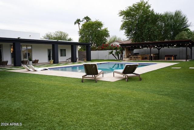 view of swimming pool with area for grilling, a yard, and a patio