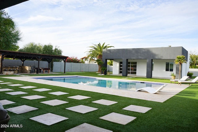 view of pool featuring a bar, a patio area, and a lawn