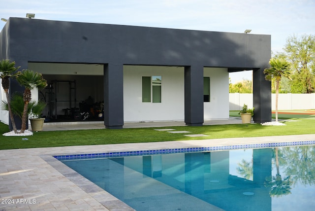 back of house with a fenced in pool and a patio area