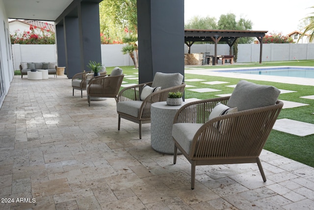 view of patio / terrace with an outdoor hangout area, a fenced in pool, and a pergola