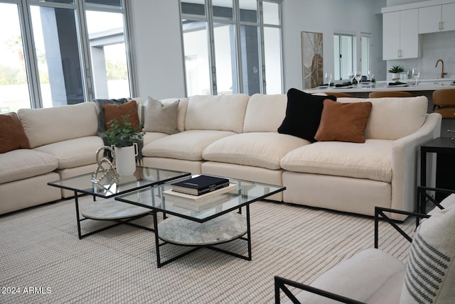 carpeted living room featuring sink