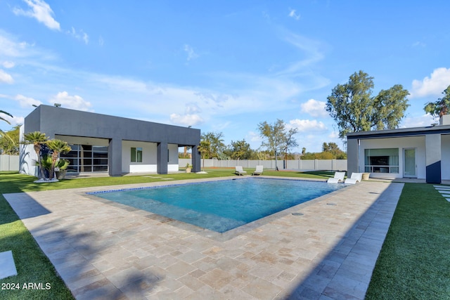 view of swimming pool featuring a lawn and a patio