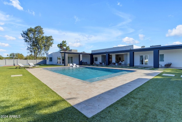 view of swimming pool featuring a patio area and a lawn