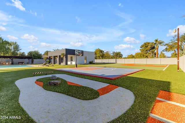 view of basketball court featuring a lawn