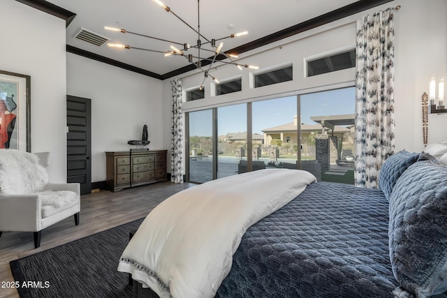 bedroom with hardwood / wood-style flooring, crown molding, access to outside, and a notable chandelier