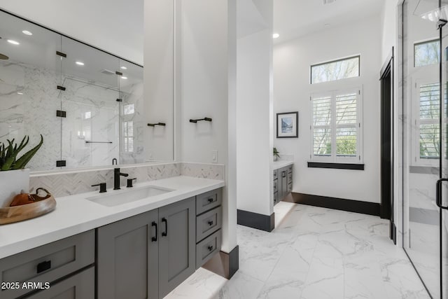 bathroom featuring vanity and a shower with door