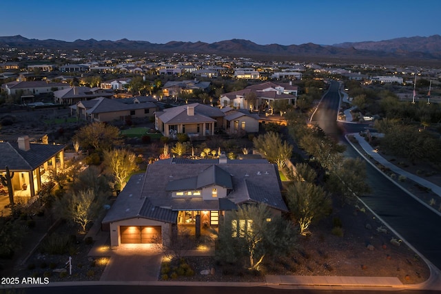 aerial view at dusk featuring a mountain view