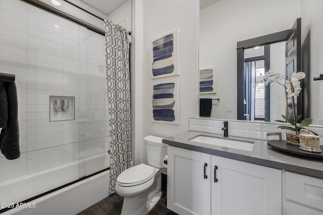 full bathroom with vanity, hardwood / wood-style floors, shower / tub combo, and toilet