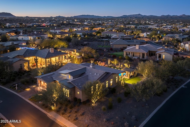 aerial view at dusk featuring a mountain view