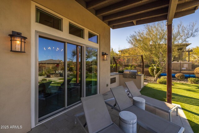 view of patio featuring an outdoor kitchen and a grill