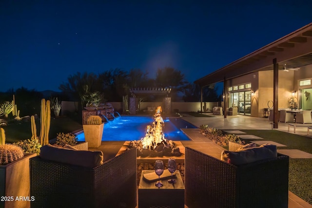 pool at twilight with a patio and an outdoor living space with a fire pit