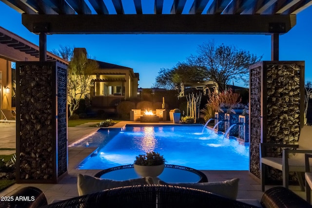 pool at dusk with a fire pit, a pergola, a patio, pool water feature, and an in ground hot tub