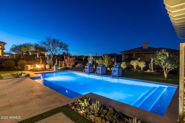 view of swimming pool with pool water feature and a patio area