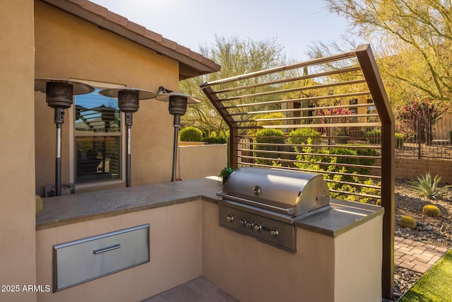 view of patio with an outdoor kitchen and area for grilling