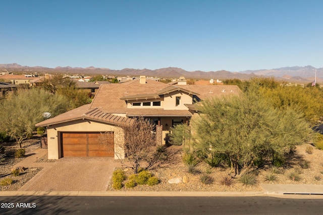 view of front facade with a garage and a mountain view