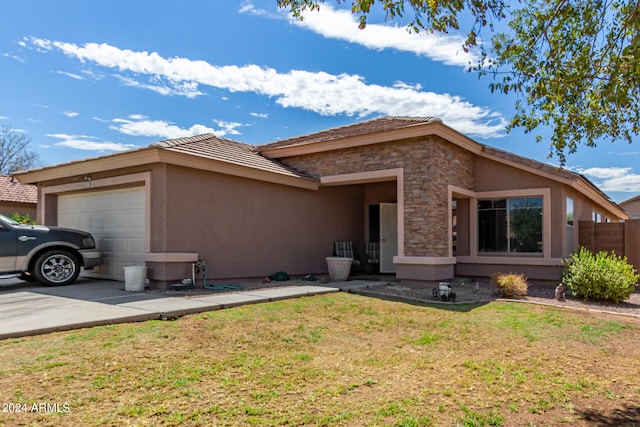 view of front facade with a garage and a front lawn