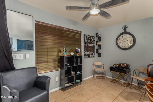 sitting room featuring light tile patterned floors and ceiling fan