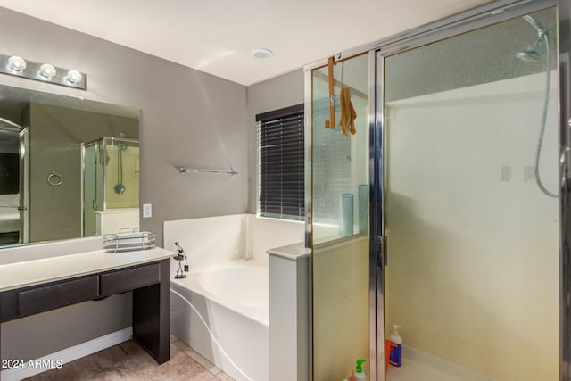 bathroom with tile patterned flooring, vanity, and separate shower and tub