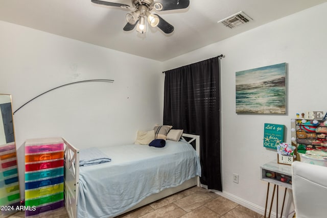 tiled bedroom with ceiling fan