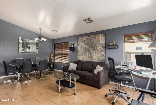 office area with a chandelier and vaulted ceiling