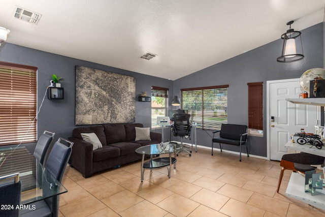 living room featuring lofted ceiling and light tile patterned floors