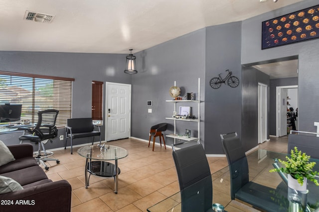 living room featuring high vaulted ceiling and light tile patterned flooring