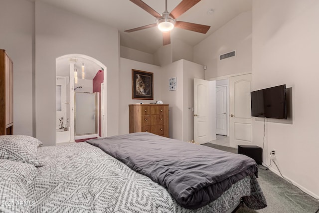 carpeted bedroom featuring arched walkways, ceiling fan, visible vents, and vaulted ceiling