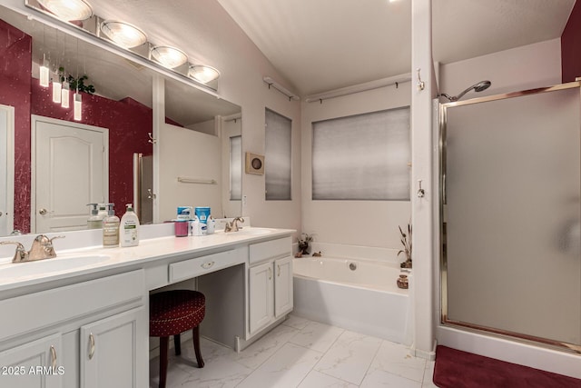 bathroom featuring a sink, marble finish floor, a bath, and a stall shower