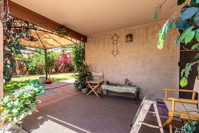 view of patio / terrace featuring a gazebo and fence