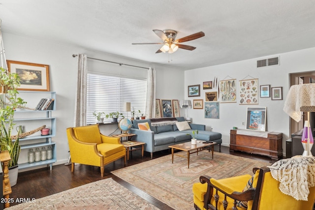 living room with a textured ceiling, dark hardwood / wood-style floors, and ceiling fan