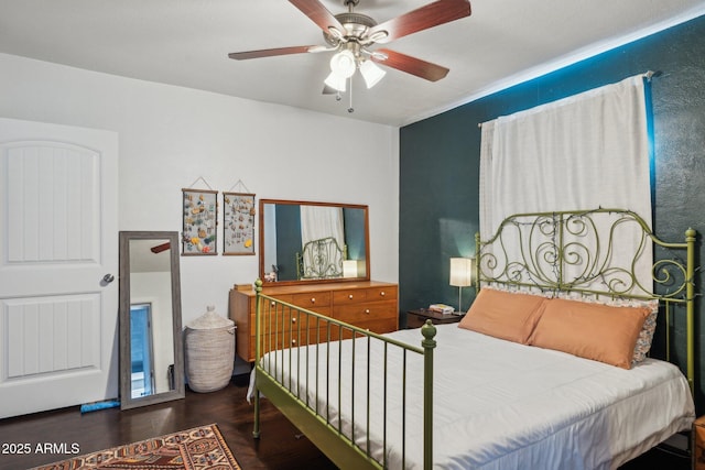 bedroom featuring ceiling fan and dark hardwood / wood-style floors