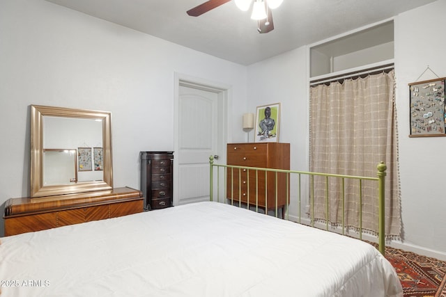 bedroom featuring ceiling fan and a closet