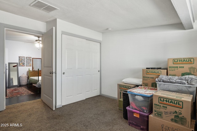 storage area featuring ceiling fan