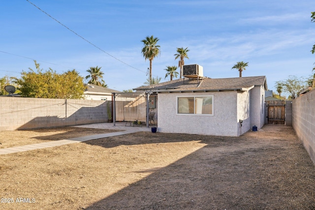 rear view of property with cooling unit