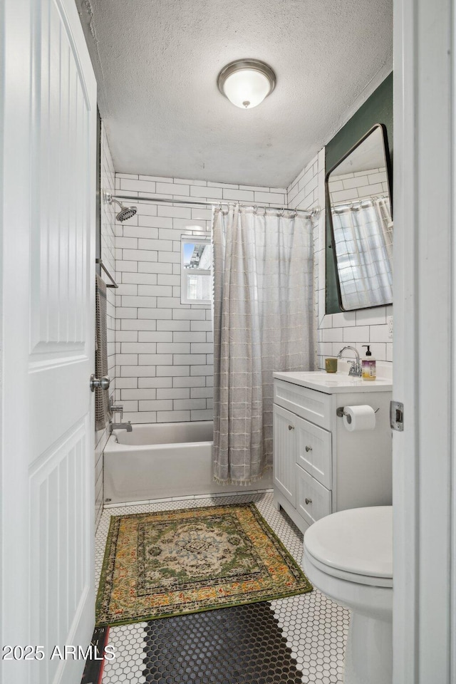 full bathroom with shower / bath combo, toilet, a textured ceiling, and vanity