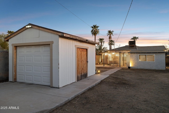 view of garage at dusk