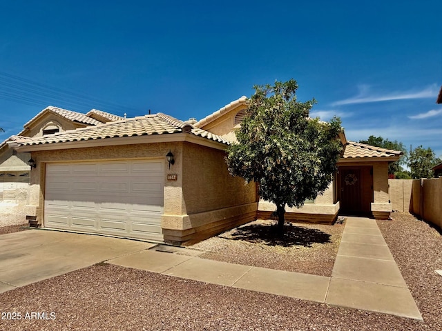 1612 E Barbarita Ave, Gilbert, AZ 85234 - view of front of house with a tile roof, fence, concrete driveway, an attached garage, and stucco siding