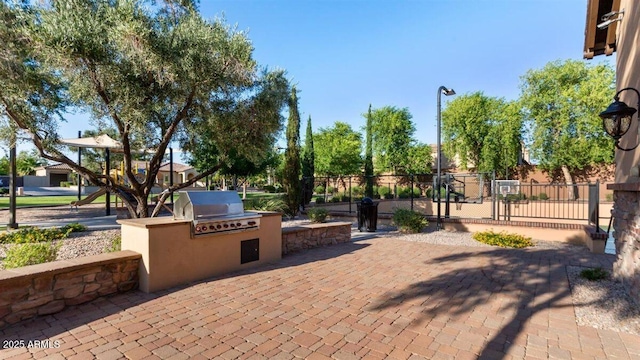 6917 E Ingram Cir, Mesa, AZ 85207 - view of patio featuring an outdoor kitchen and a gate