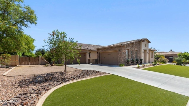 6917 E Ingram Cir, Mesa, AZ 85207 - view of front of home with an attached garage, driveway, stone siding, and a gate