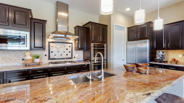 6917 E Ingram Cir, Mesa, AZ 85207 - kitchen featuring stainless steel appliances, wall chimney exhaust hood, light stone counters, backsplash, and recessed lighting