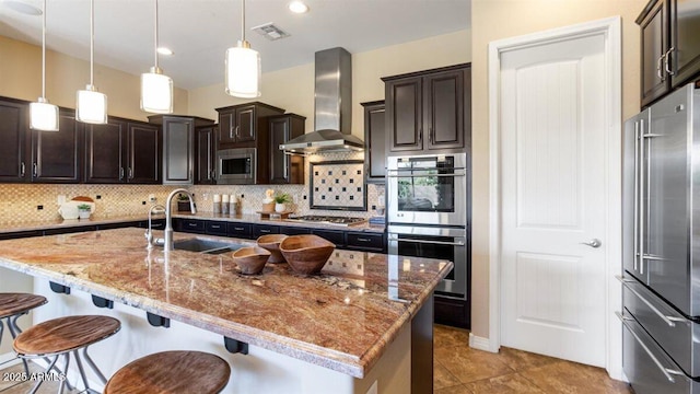 6917 E Ingram Cir, Mesa, AZ 85207 - kitchen featuring stainless steel appliances, wall chimney exhaust hood, tasteful backsplash, and a kitchen bar